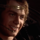 Screenshot from Star Wars: Revenge of the Sith where Anakin Skywalker smiles while piloting a spaceship.
